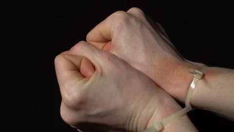 Hands are released from the plastic handcuffs with a missing hostage. Stock Footage 122382279