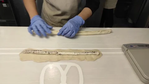 Hands are rolling the dough then cutting it into few pieces Stock Footage 260202895