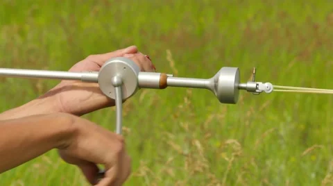 Hands Are Rotating a Rubber Engine Sports Competition in Green Field 動画素材 64580505