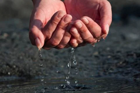 Hands are scooping water Stock Photos