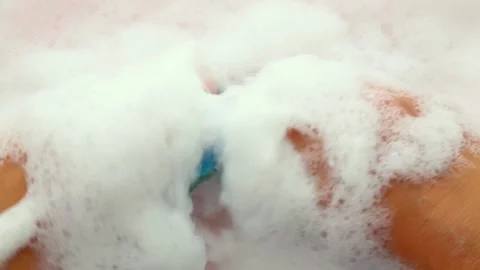 The hands are smoothly immersed in the foam with small washcloths, Asmr. Part 6 Stock-Footage 281674812