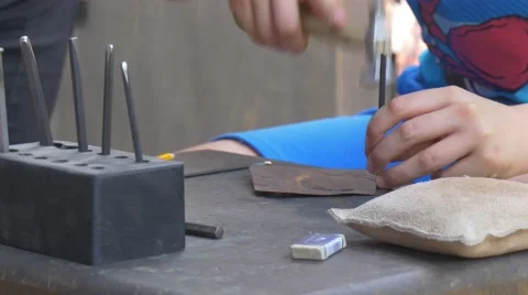 Hands Are Stamping a Pattern on Cooper Plate Participants od the Festival Are Stock Footage 64358808