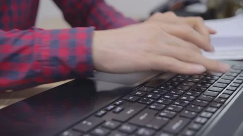 Hands are typing text on a laptop Stock Footage 69940337
