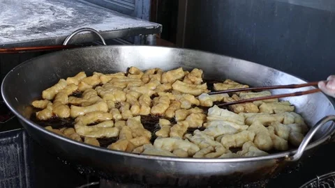 Hands are using chopsticks making deep fried dough stick Stock Footage 152435838