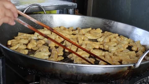 Hands are using chopsticks making deep fried dough stick Stock Footage 152598058