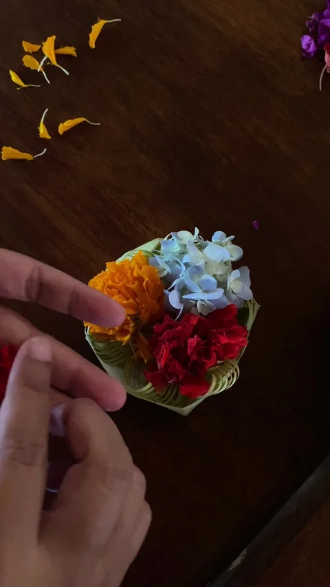 Hands Arranging Colorful Flowers in Leaf Bowl Stock Footage 277315846