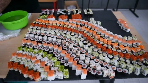 Hands arranging different sushi appetizers on a plate Video stock 72388042