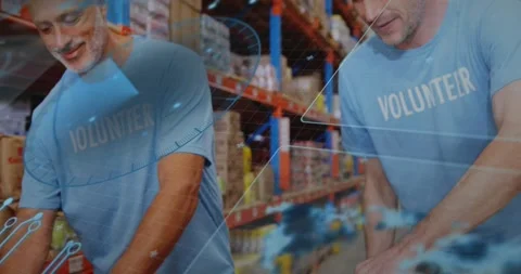 Hands arranging groceries initiating pullback, two volunteers packing while HUD Stock-Footage 320725676