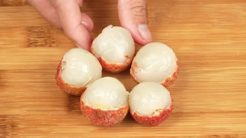 Hands Arranging Peeled Ripe Lychee Fruits in Flower Shape on Board Vídeos de archivo 337325827