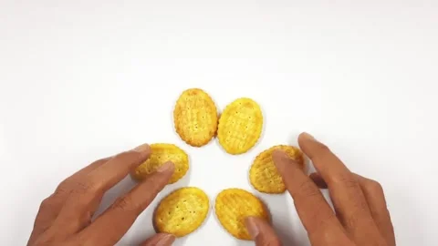 Hands arranging salty round crackers into a pattern video footage Stock Footage 331512727