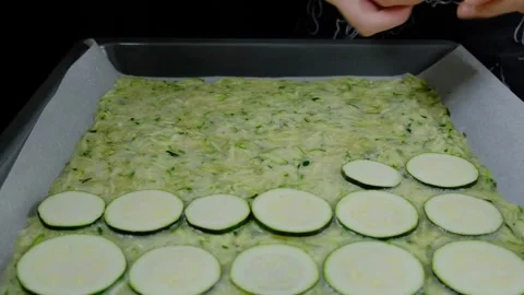 Hands Arranging Zucchini Slices in Baking Dish Cooking Stock Footage 341454685