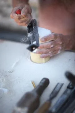 Hands of an artisan in the processing of limestone in the workshop Stock Photos