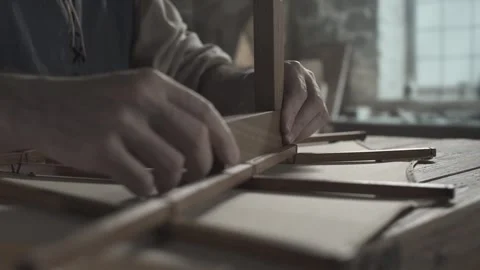 Hands of an artist testing the angles of an ornithopter wing with a wooden ruler 스톡 동영상 339631376