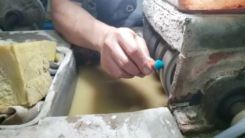 The hands of an asian man agate craftsman who is sharpening Stock Footage 168914532