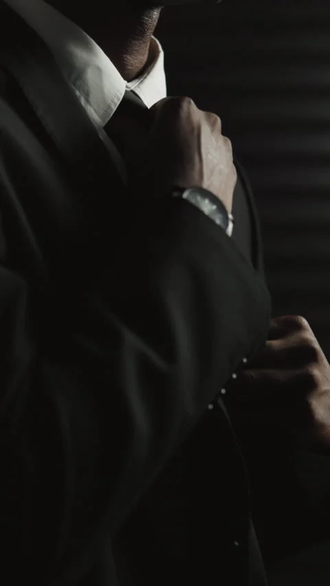Hands, assassin and suit with getting ready for secret mission, espionage and Stock Footage 334048732