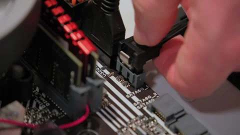 Hands assemble data link to mother board in PC. Close up 動画素材 268302965