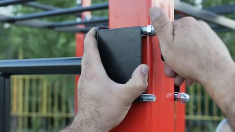 The hands of the assembler of the assembler tighten the nut with their fingers Stock Footage 197569630