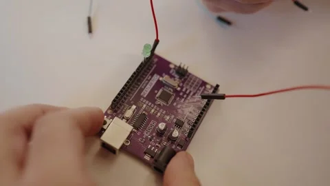 Hands Assembling Circuit Board with Wires and Microchips Stock Footage 322889147