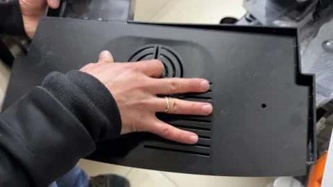 Hands assembling two plastic parts of the drip tray from a coffee vending Stock Footage 336977263