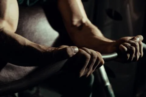 Hands of an athlete close-up, which does an exercise with a barbell. gym. biceps Stock Photos