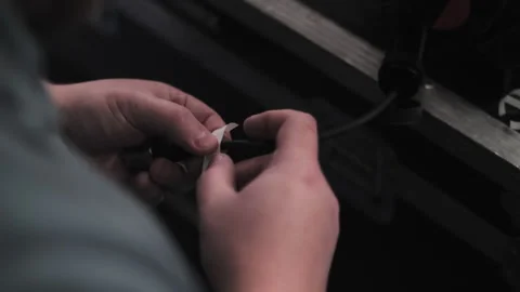 Hands attaching label to stage cable Video stock 308625487