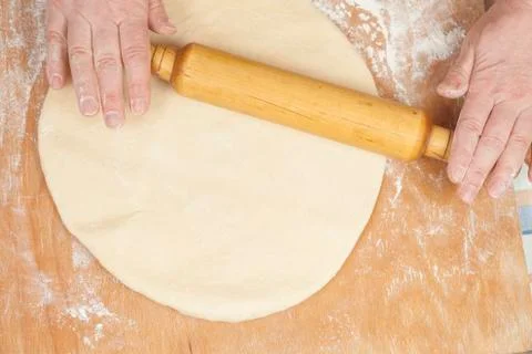 Hands baking dough with rolling pin Stock Photos