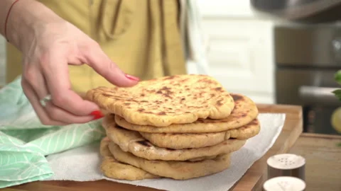 Hands baking pita and stacking pile of turkish pitta Stock Footage 138749464