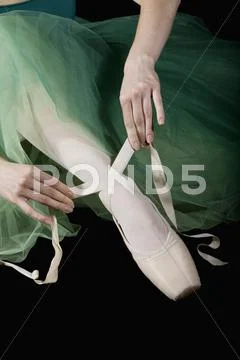 The Hands Of Ballet Dancer Tying A Pointe Shoe
