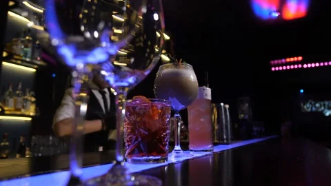 Hands of bar customers taking prepared cocktails Stock Footage 105595151