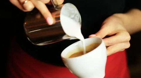 Hands of barista making latte or cappuccino coffee pouring milk making latte art Stock Footage 61042521