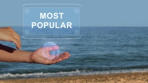 Hands on beach hold hologram text Most popular Stock Footage 106935479