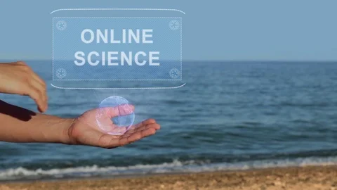 Hands on beach hold hologram text Online science Stock Footage 106935574