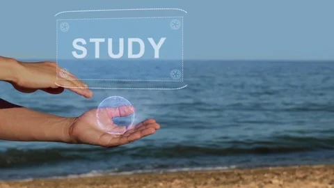 Hands on beach hold hologram text Study Stock Footage 107130683