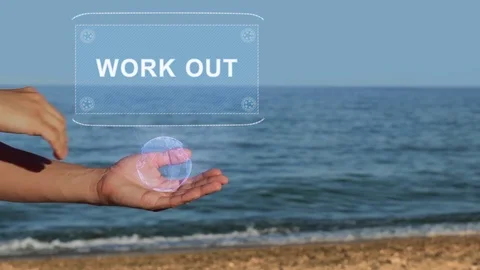 Hands on beach hold hologram text Work out Stock Footage 107271861
