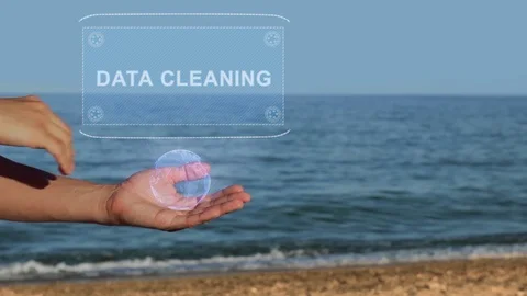 Hands on beach hold hologram text Data cleaning Stock Footage 107436134