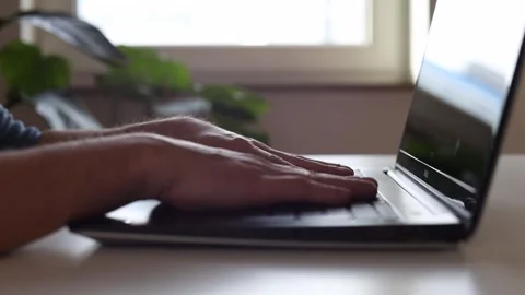 Hands behind a laptop, thinking where to start Stock Footage 244599131