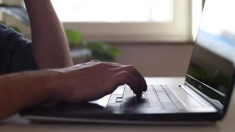 Hands behind a laptop, thinking where to start 動画素材 244599136