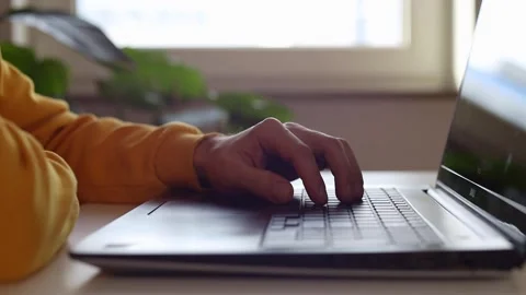 Hands behind a laptop, thinking where to start 動画素材 244599139
