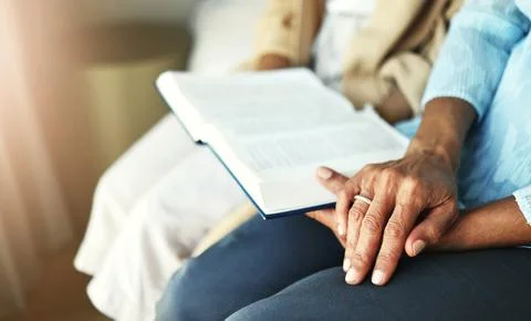 Hands, bible and senior couple praying in their home together for scripture Stock Photos