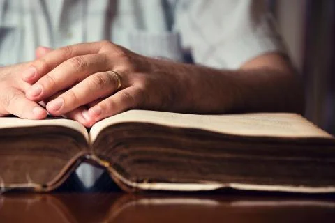 Hands on bible Stock Photos
