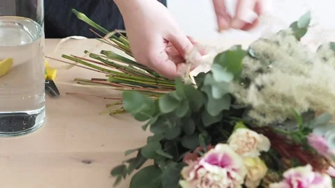 Hands binding a bouquet, close up shot Stock Footage 168329579