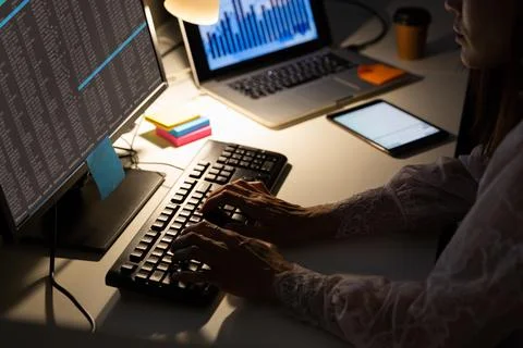 Hands of biracial female programmer sitting at desk, using computer with coding 스톡 사진