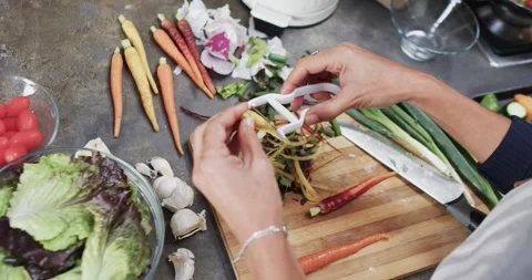 Female hands making butternut squash noodles with a vegetable peeler.Top  view Stock Photo - Alamy