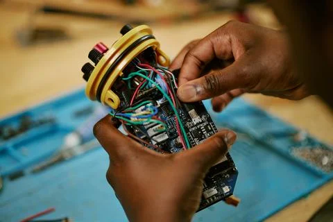 Hands of Black Engineer Assembling Electronic Hardware Device Stock Photos