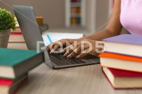 Hands of black female student typing on laptop keyboard Stock Photos