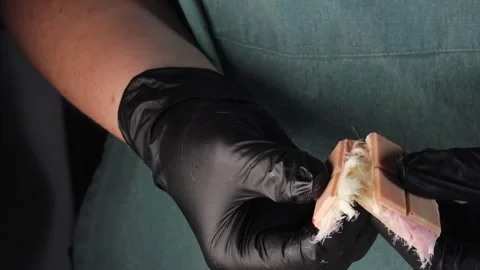 Hands in black gloves breaking chocolate with pismaniye filling Stock Footage 305168770