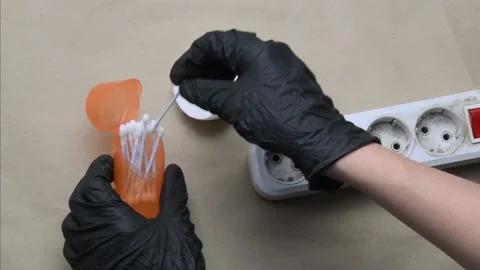 Hands in black gloves clean dirty plastic extension socket. Cleaning electric 스톡 동영상 157605613