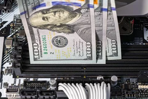 Hands in black gloves inserting 100-dollar bills into empty RAM slots on a .. Stock Photos