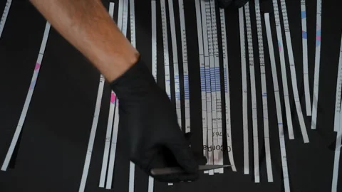 Hands in black gloves reassembling shredded document, secrecy, data recovery. Stock Footage 304303957