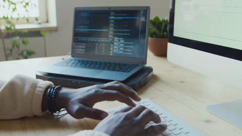 Hands of Black Male Programmer Writing Code on Laptop then Testing Stock Footage 293119681